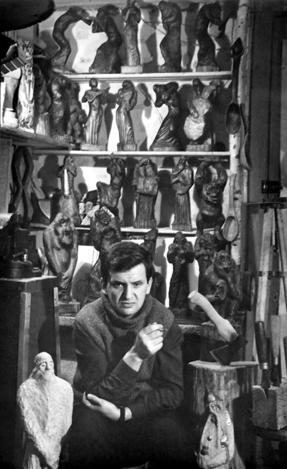 Eduard Bersudsky surrounded by his wooden sculptures on shelves